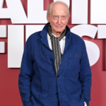 Charles-Dance-Movie-Power-Ballad-2026-Fred-Powell-Blue-Jacket.webp